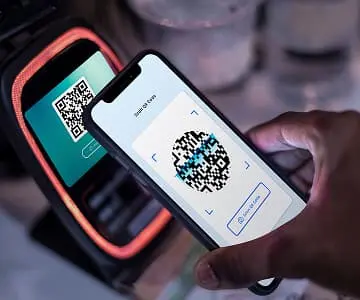 A hand that shows QR code payment
